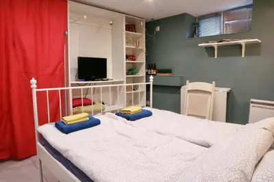 a bedroom with a bed and a tv in a room at Sofia Center Cave in Sofia