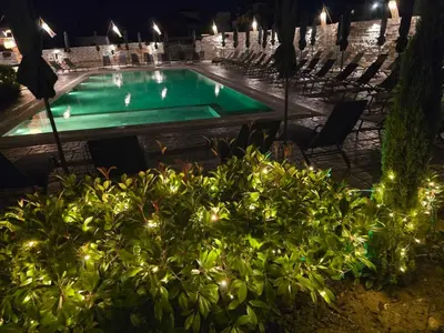a swimming pool at night with lights at Boutique Hotel Colosseo in Sandanski