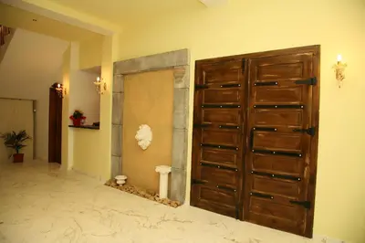 a large wooden door in a room at Boutique Hotel Colosseo in Sandanski