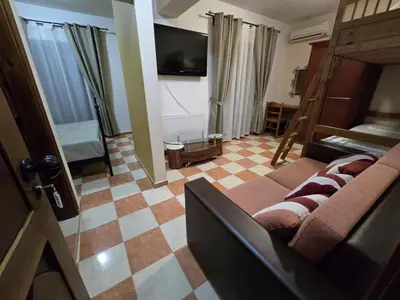 a living room with a couch and a television at Boutique Hotel Colosseo in Sandanski