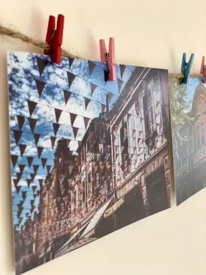 a picture hanging on a clothes line with clothespins at Flamingo Plovdiv in Plovdiv