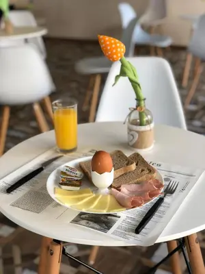 a plate of breakfast food on a table at Flamingo Plovdiv in Plovdiv