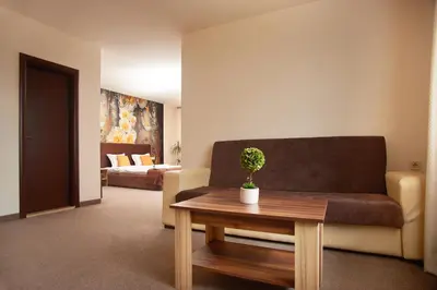 a living room with a couch and a table at Flamingo Plovdiv in Plovdiv