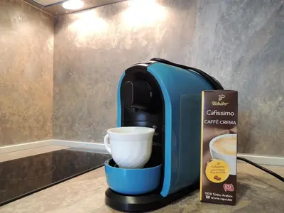 a coffee maker sitting on a counter next to a cup at Хисаря ВИП апартаменти in Hisarya