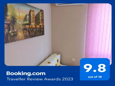 a bedroom with a painting hanging on the wall at Хисаря ВИП апартаменти in Hisarya