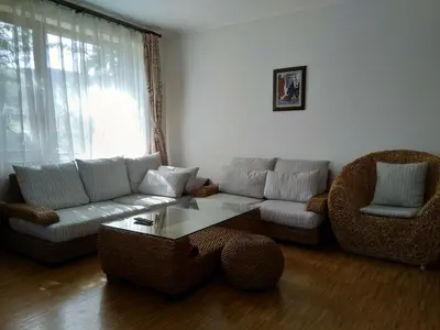 a living room with a couch and a table and chairs at Вила Цветелина, Комплекс Александриa in Dobrinishte