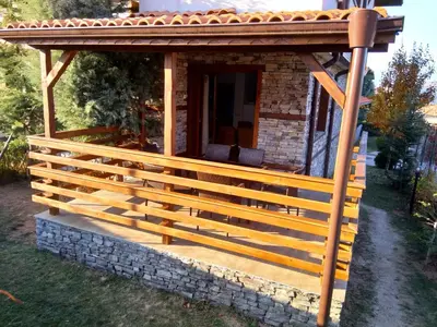 a wooden gazebo with a roof on top at Вила Цветелина, Комплекс Александриa in Dobrinishte
