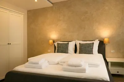 a bedroom with a large bed with towels on it at Shahbazian House in Plovdiv