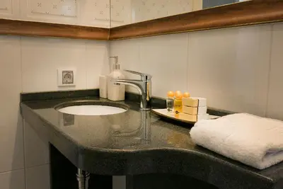 a bathroom counter with a sink and a towel at Shahbazian House in Plovdiv