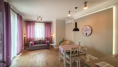 a living room with a table and a chair at Shahbazian House in Plovdiv