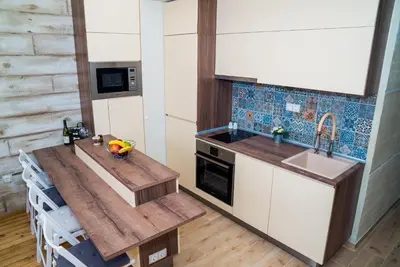 a kitchen with a wooden table and a sink at Sofia Central Luxury Apartment in Sofia