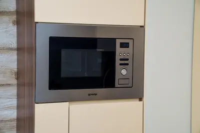 a microwave oven is attached to a wall at Sofia Central Luxury Apartment in Sofia