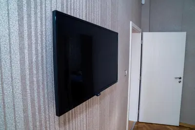 a flat screen tv hanging on a wall at Sofia Central Luxury Apartment in Sofia