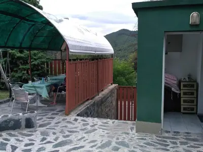a pavilion with a table and chairs and a tent at семеен хотел 