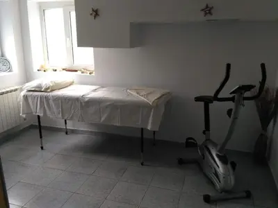 a room with a bed and a exercise bike at семеен хотел 