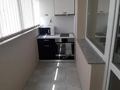 a small kitchen with a stove and a microwave at Guest House Mania in Sofia