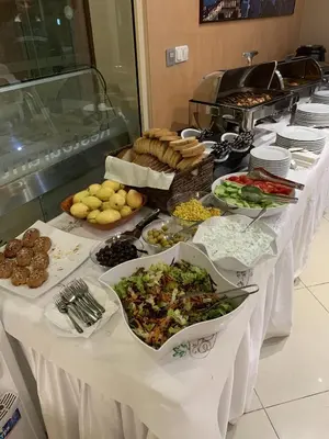 a buffet line of food on a table at City Hotel Plovdiv FREE PARKING in Plovdiv