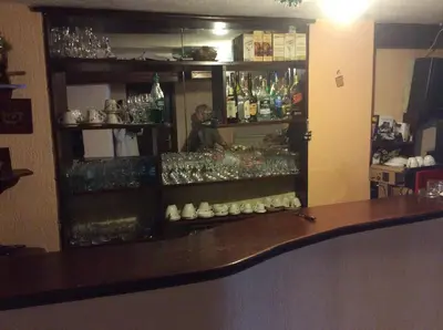 a bar with a bunch of glasses on shelves at Hotel Balevurov in Sandanski