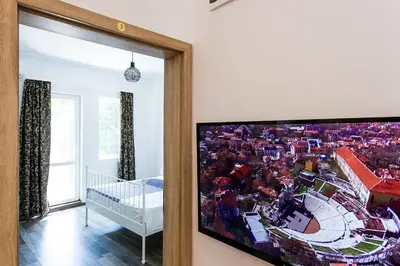 a large flat screen tv hanging on a wall in a room at Top center big family apartment with garden view in Plovdiv