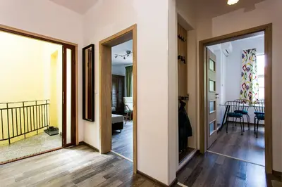 a hallway with doors leading to a living room at Top center big family apartment with garden view in Plovdiv