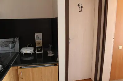 a kitchen with a door leading into a room at Pamporovo Hotel Snezhanka A425 in Pamporovo
