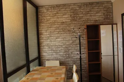 a room with a table and a brick wall at Pamporovo Hotel Snezhanka A425 in Pamporovo