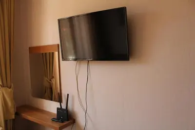 a flat screen tv hanging on a wall at Pamporovo Hotel Snezhanka A425 in Pamporovo