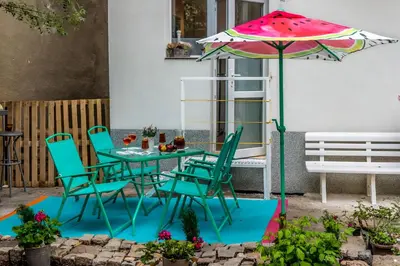 a table and chairs and an umbrella on a patio at Urban Garden in Sofia
