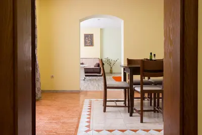 a dining room with a table and a living room at Apartments Nasini by Flat Mаnager in Plovdiv