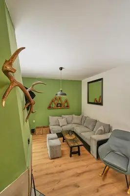 a living room with a couch and a table at Пе́трови Вили in Ribarica