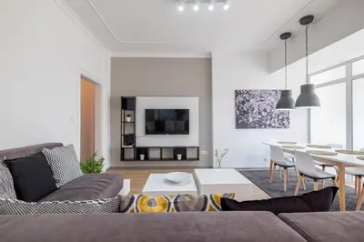 a living room with a couch and a table at blueWaveplace - Stylish 2 BR Home in Center of Sofia in Sofia