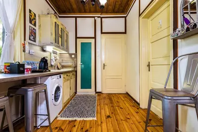 a kitchen with a washer and dryer next to a door at Blacksmith's House - Old Town in Plovdiv
