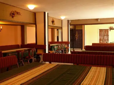 an empty room with tables and chairs and a room with tables and chairs at Почивна станция Витоша in Velingrad