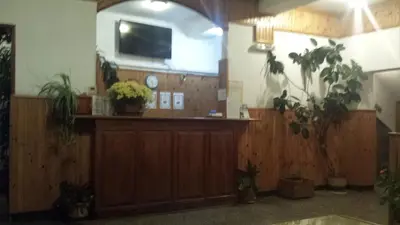 a lobby with a waiting area with potted plants at Почивна станция Витоша in Velingrad