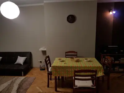 a living room with a table and a couch at Artistic studio in Sofia's top center in Sofia