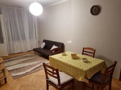 a living room with a table and a couch at Artistic studio in Sofia's top center in Sofia