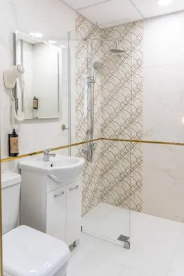 a bathroom with a shower and a toilet and a sink at Art Hotel Simona in Sofia