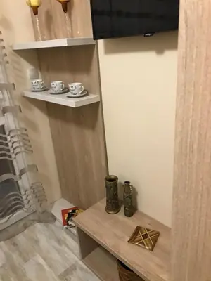 a room with a table and some cups on a shelf at ФЛАМА РЕЗИДЕНТС in Plovdiv