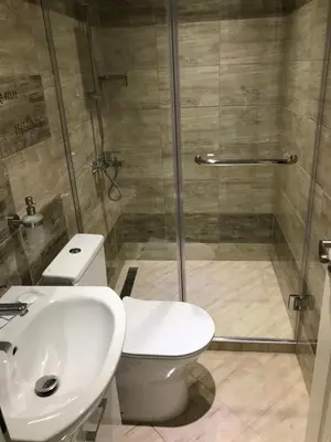 a bathroom with a shower and a toilet and a sink at ФЛАМА РЕЗИДЕНТС in Plovdiv