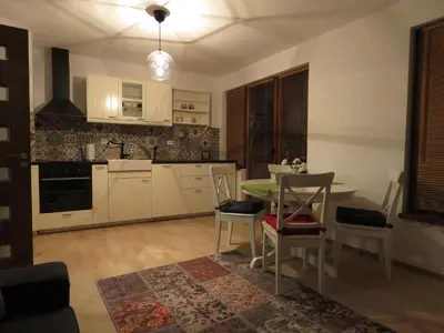 a kitchen with a table and chairs in a room at Willy Villy's Home- Chepelare in Chepelare