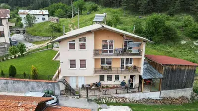 a large house with a balcony on a hill at Къща за гости МЕЛИСА in Borino
