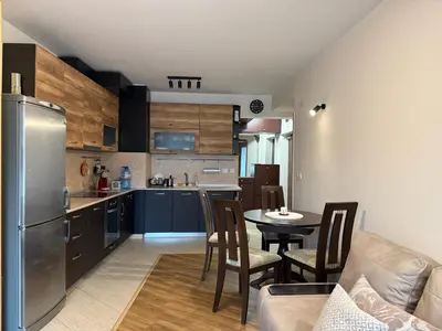 a kitchen and living room with a table and a refrigerator at Kamy-Sophia Apartment in Sofia