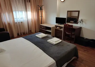 a bedroom with a bed and a desk and a mirror at Family 2 bed Apartment in Bansko in Bansko