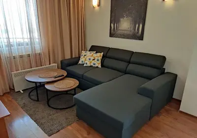 a living room with a couch and a table at Family 2 bed Apartment in Bansko in Bansko