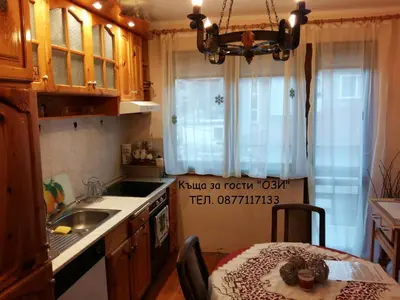 a kitchen with a sink and a table with a tableablish at Къща за гости Ози in Ovchartsi