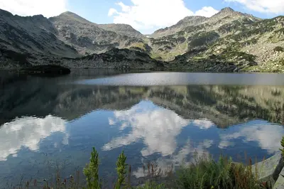 a lake in the middle of a mountain range at Cozy Apartment Next to Gondola in Bansko