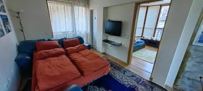 a living room with a couch and a flat screen tv at Cozy Apartment Next to Gondola in Bansko