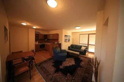 a living room with a couch and a table at Cozy Apartment Next to Gondola in Bansko