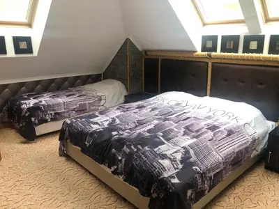 a bedroom with two beds in a attic at Стаи за гости Топ Старс Смолян in Smolyan