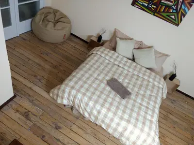 a bedroom with a bed with a checkered blanket at Good Stay Sofia Apartments in Sofia